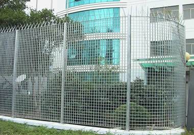 Welded steel grating fence around a commercial building